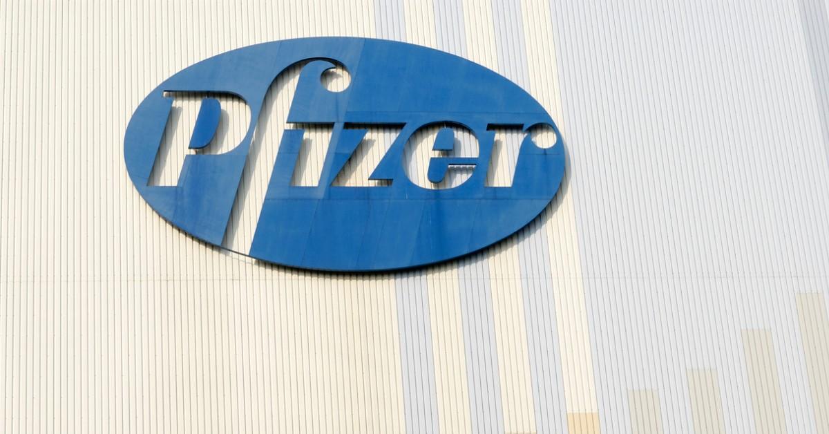 The blue Pfizer logo on the side of a building